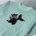 BÜGELBILD "SHIT HAPPENS"